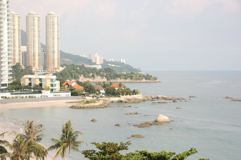 The vibrant Batu Ferringhi Night Market at dusk, with stalls glowing and crowds browsing