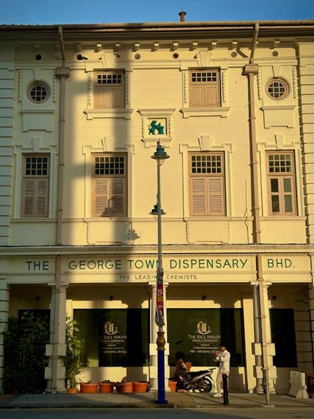 A local artisan at work in a George Town shop