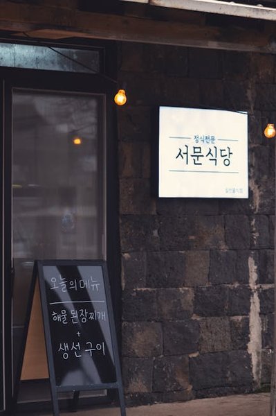 An artist adds a new piece to a wall in a back alley, representing the evolving nature of the scene